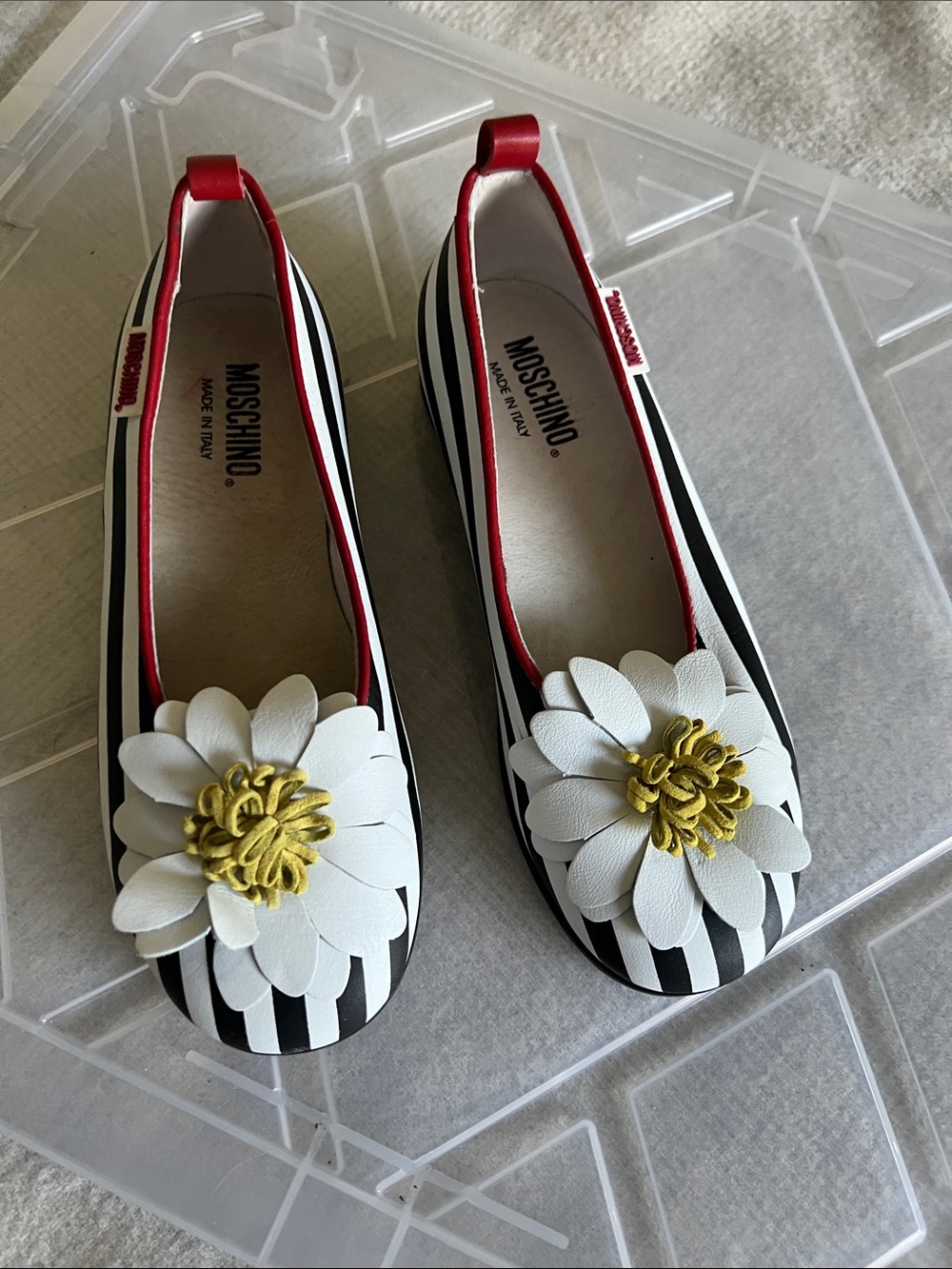 Moschino Women’s Black & White Striped Ballet Flats with White Floral Accent.